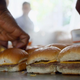 hands preparing white castle slider